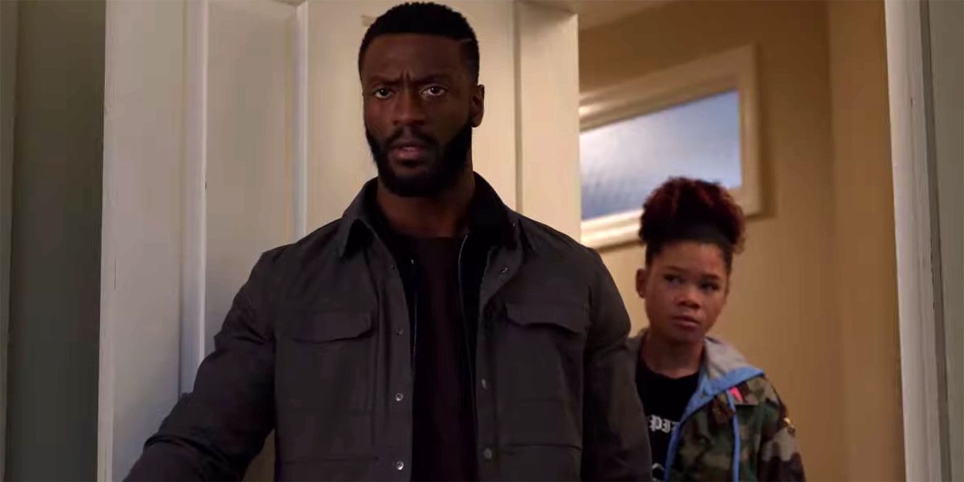 aldis hodge and storm reid look into a doorway with converned looks in the invisible man
