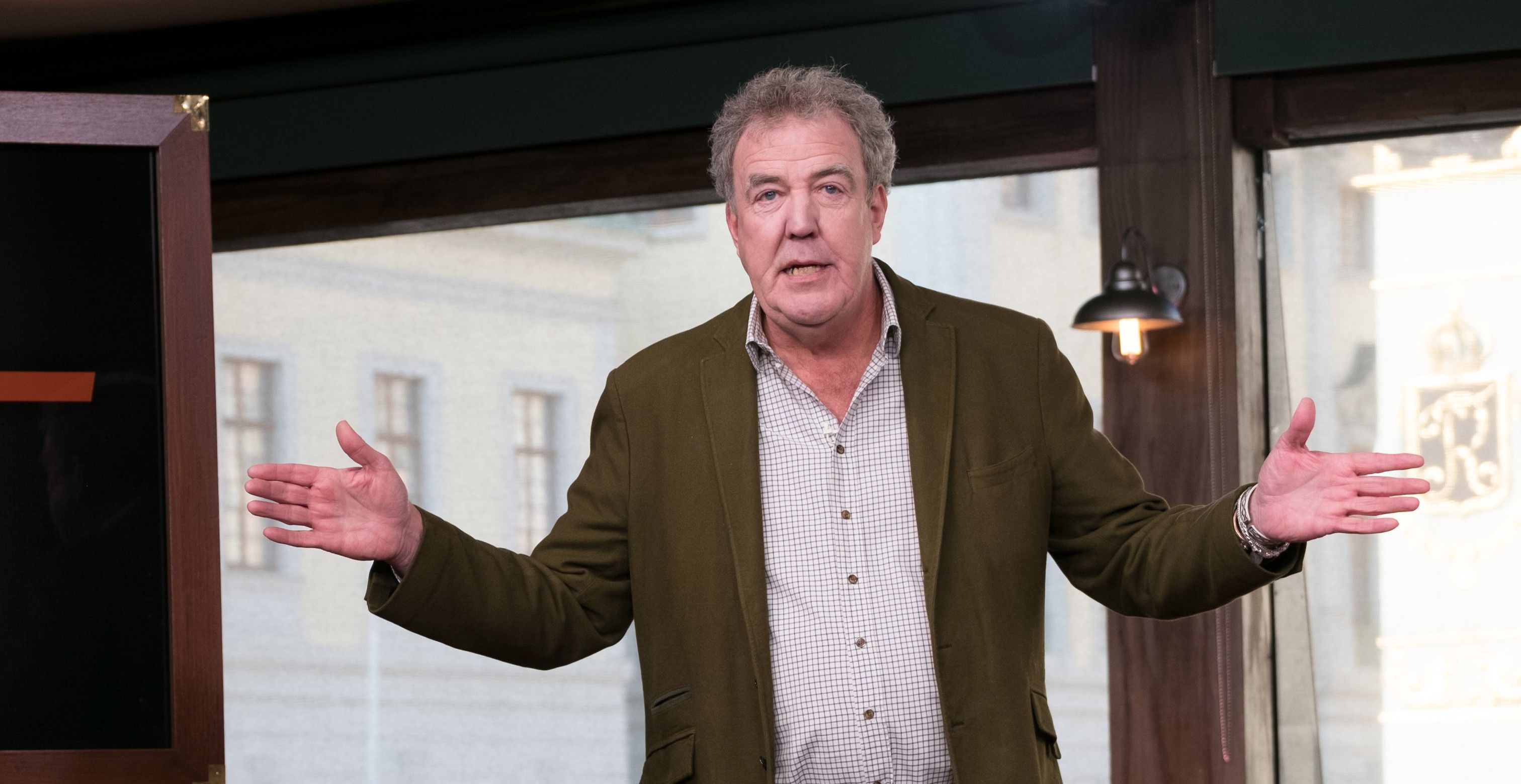 Jeremy Clarkson is shrugging his arms in the Grand Tour studio
