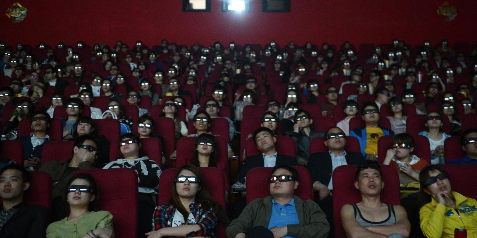 People watch the screen in a movie theatre