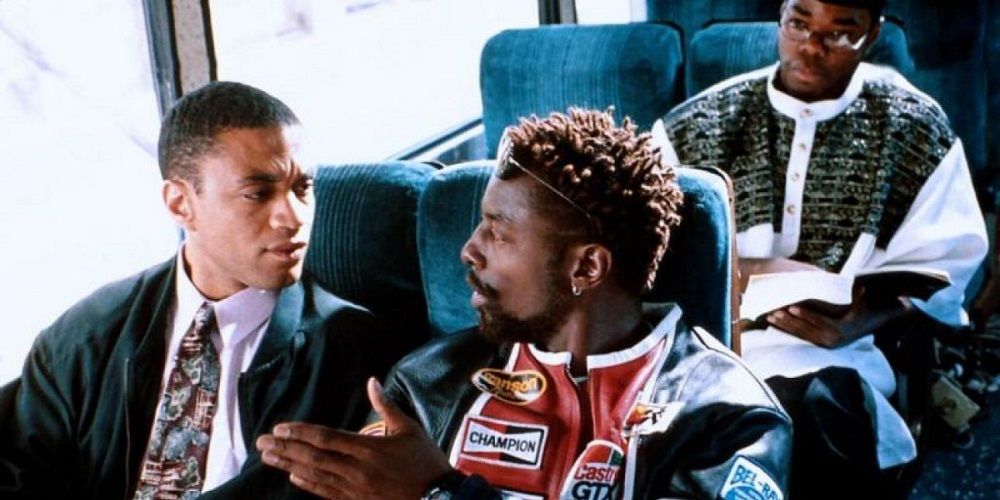 Two men talking while on a bus in Get On The Bus.
