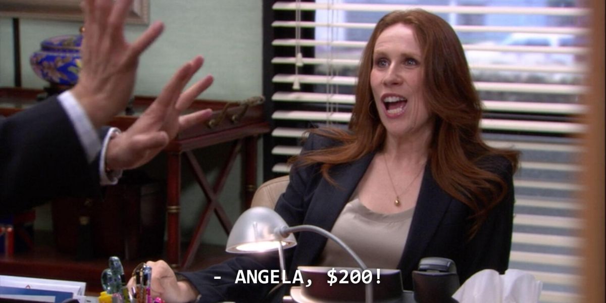 Nellie arguing with Andy at her desk on The Office