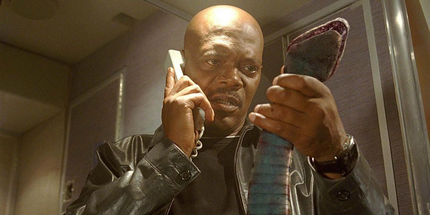Neville Flynn on the phone while holding a snake in Snakes on a Plane