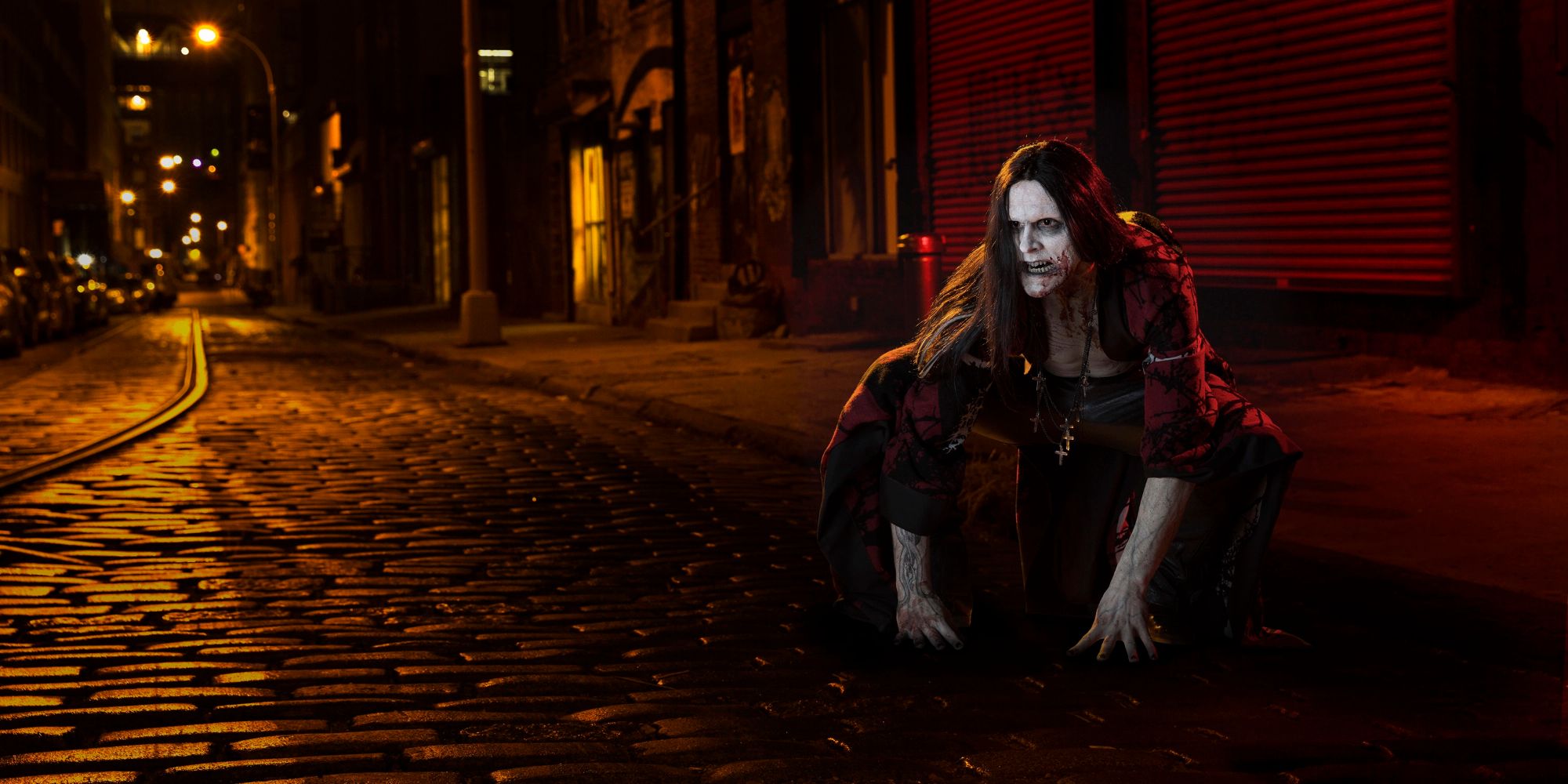 A vampire crouching on a road in The Strain