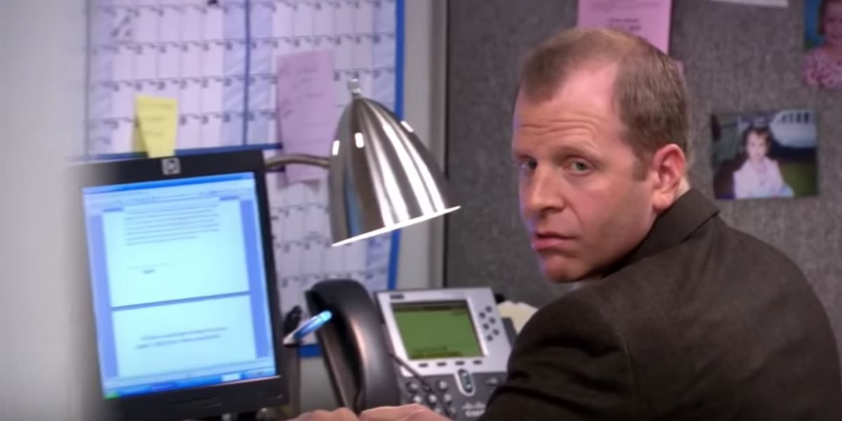 Toby sitting at his desk, looking at the camera on The Office