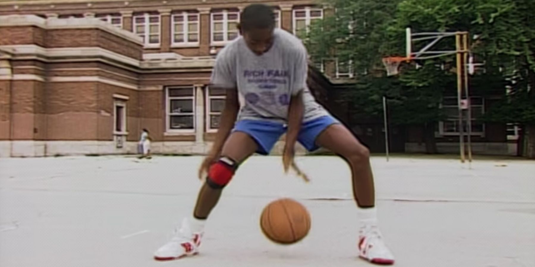 A young man playing basketball in Hoop Dreams.