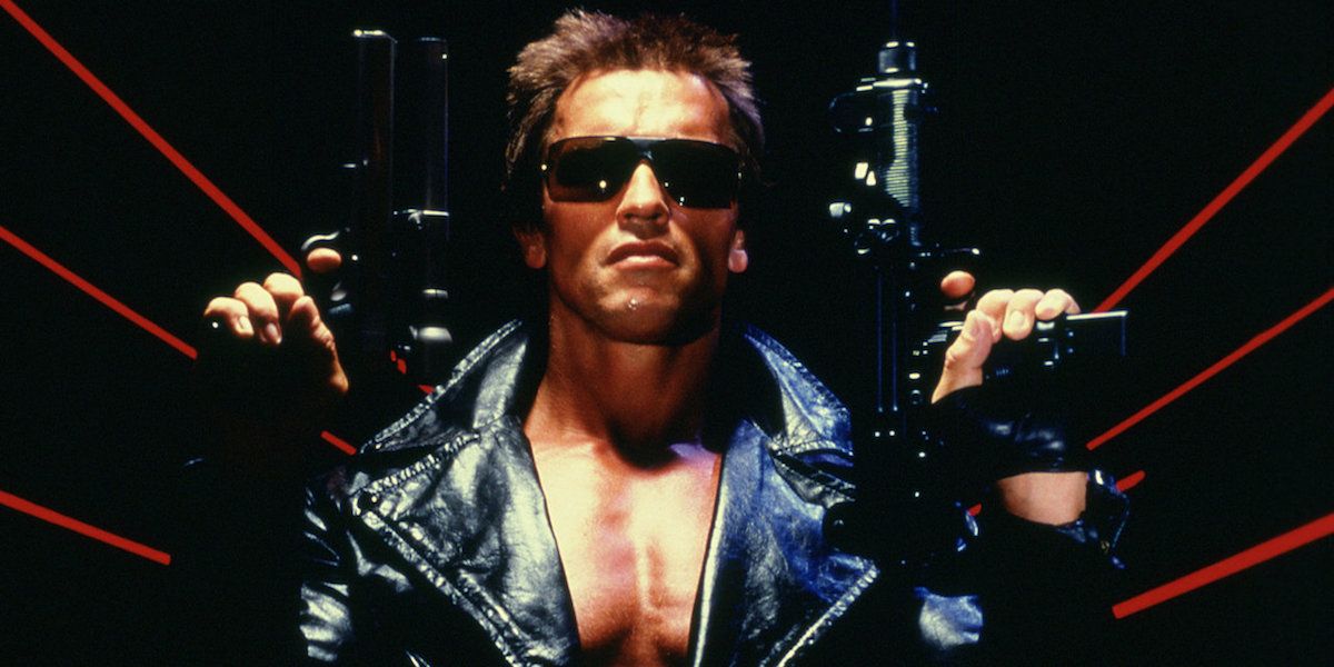 Arnold Schwarzenegger holding two guns in the poster for The Terminator surrounded by red lines