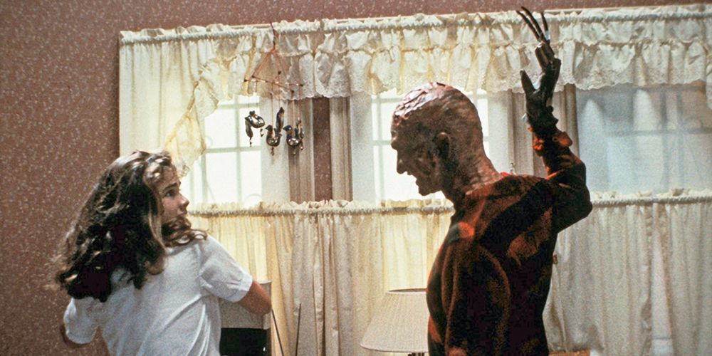 Nancy scared in her kitchen with Freddy Kruger nearby in A Nightmare On Elm Street