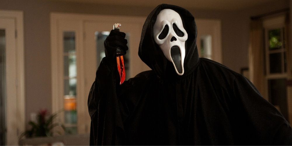 The Ghostface killer brandishing a knife in Scream