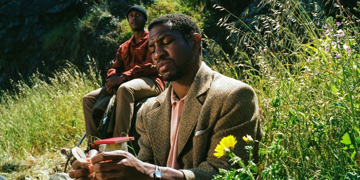Jonathan Majors doing crafts in the mddle of a field in The Last Black Man in San Francisco 