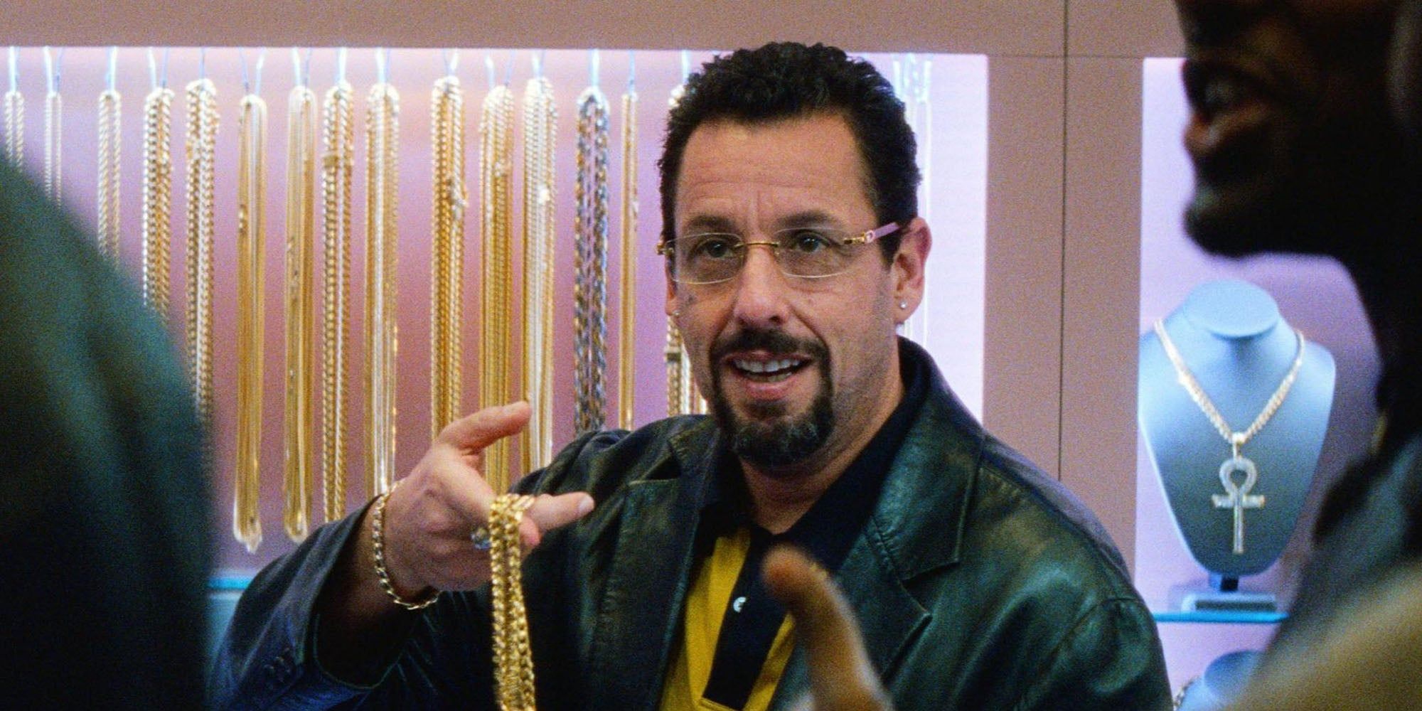 Adam Sandler holding a gold chain in Uncut Gems