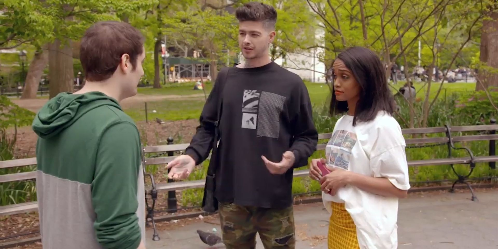 Hosts Travis Mills and Rachel Lindsay talking to a cast member on Ghosted