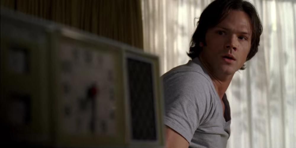 Sam Winchester wakes up and looks at the clock in Supernatural.