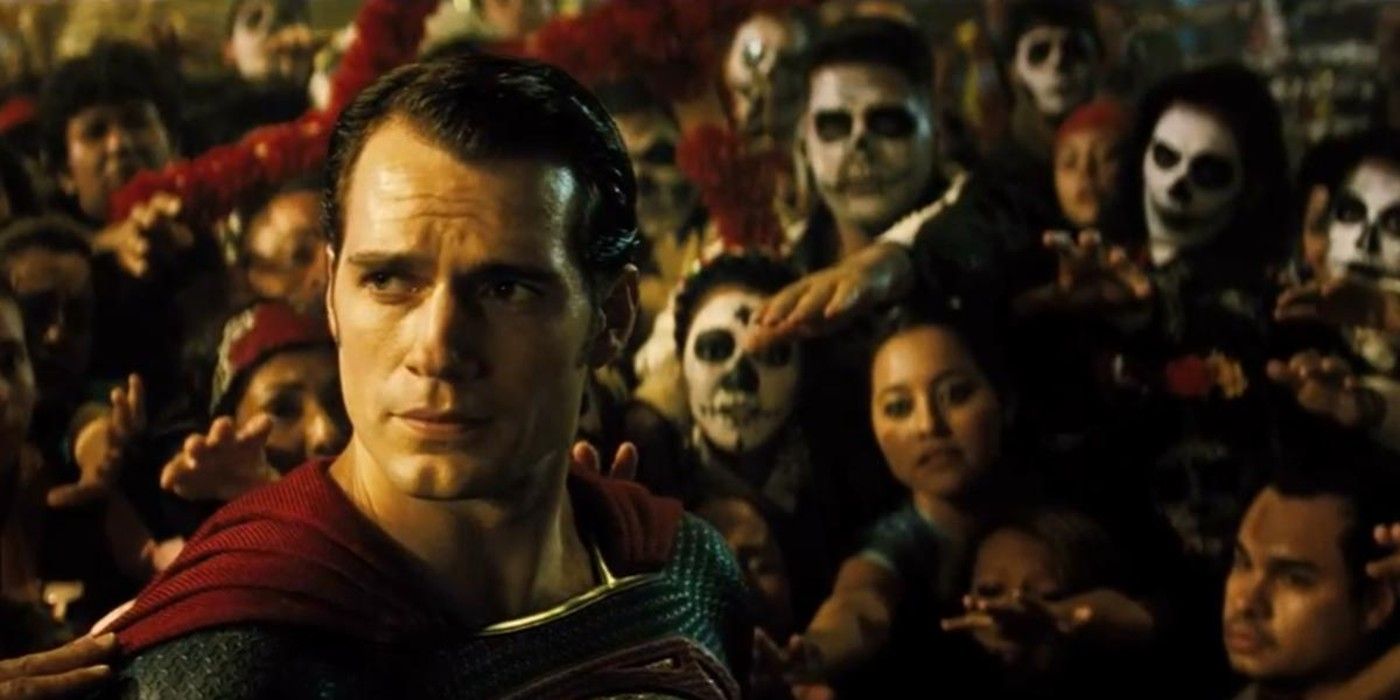 Superman looks overwhelmed as people in Day of the Dead makeup reach out to him in Batman v Superman