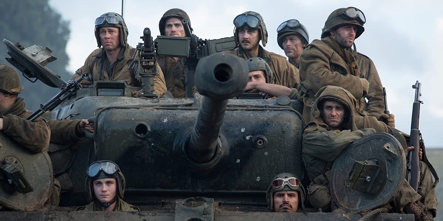 The crew sit on the tank in Fury