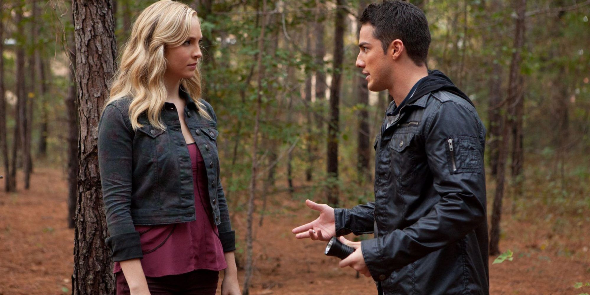 Caroline and Tyler talking in the woods in The Vampire Diaries.
