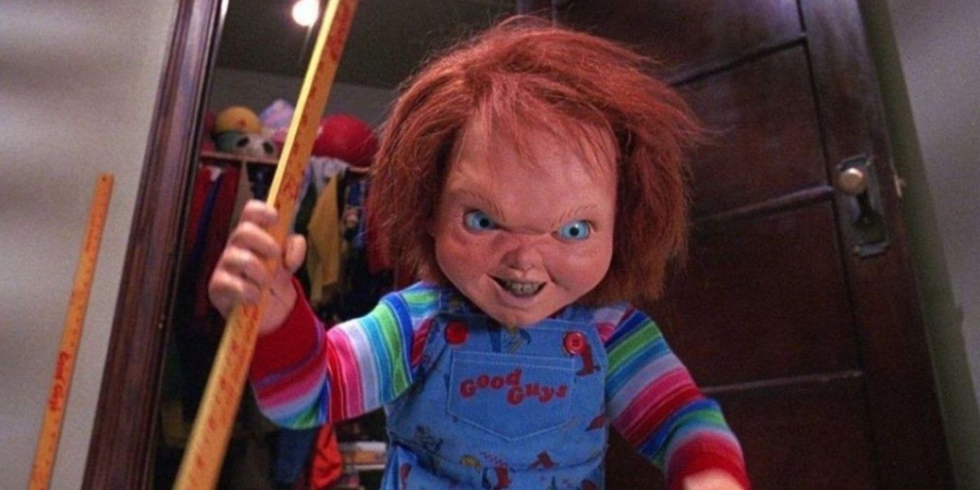 Chucky from Child's Play holding a metre stick and looking evil.