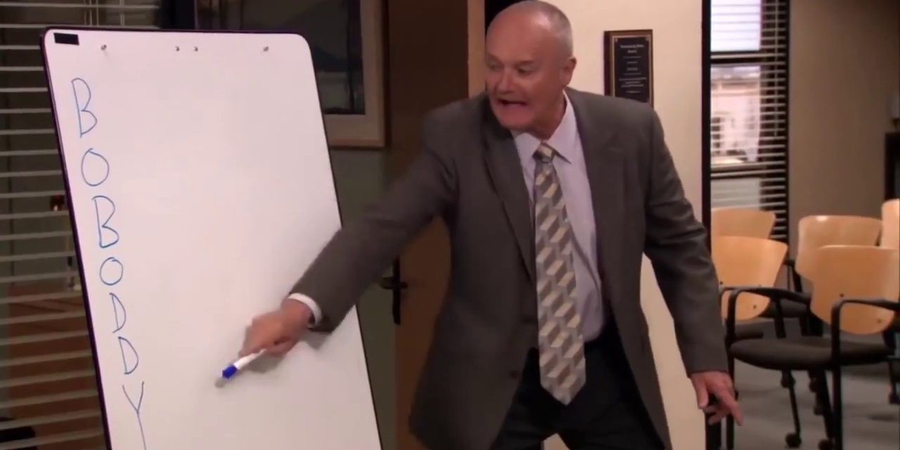 Creed Bratton pointing to the board in The Office