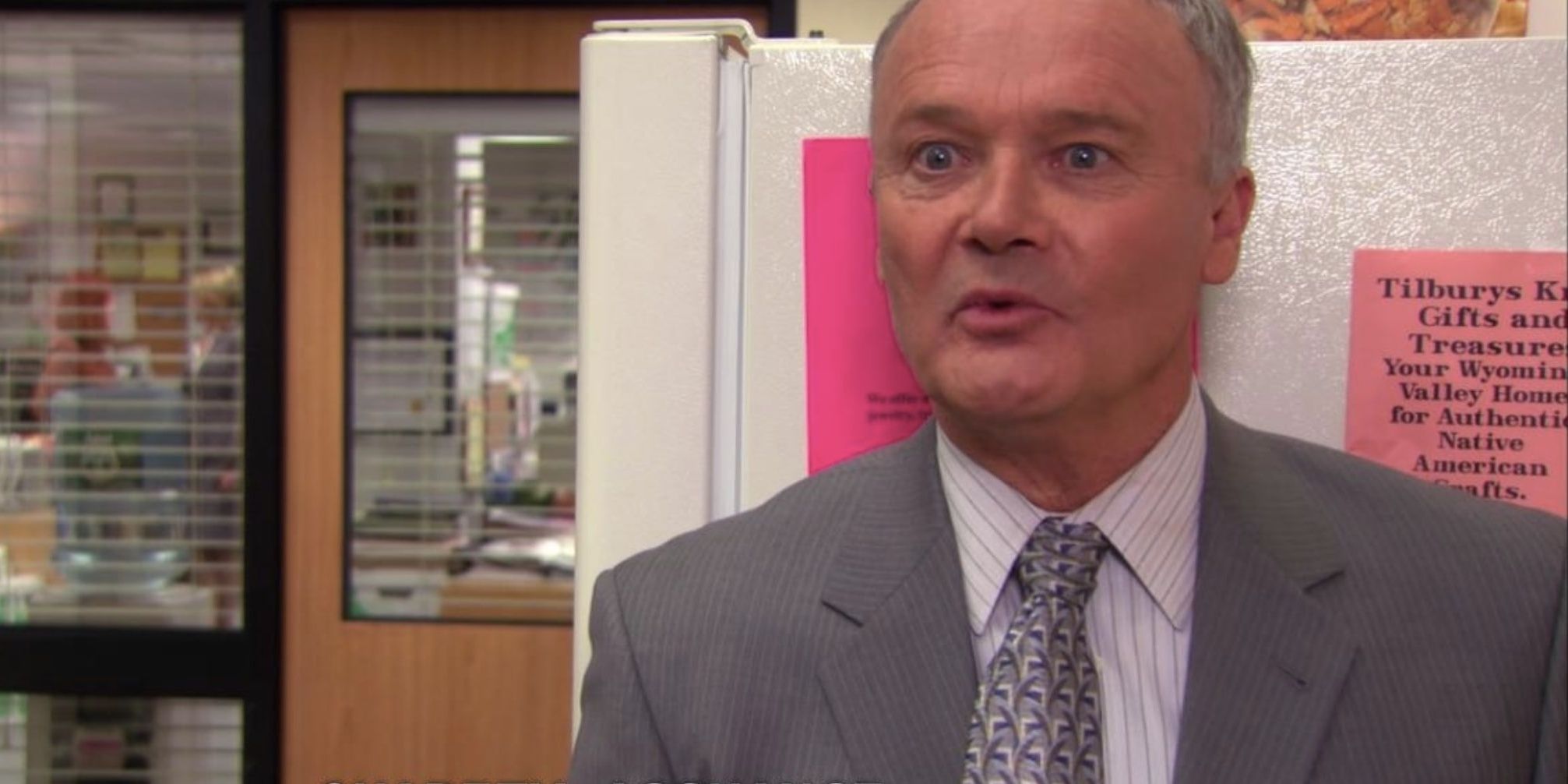 Creed hiding behind a fridge in The Office