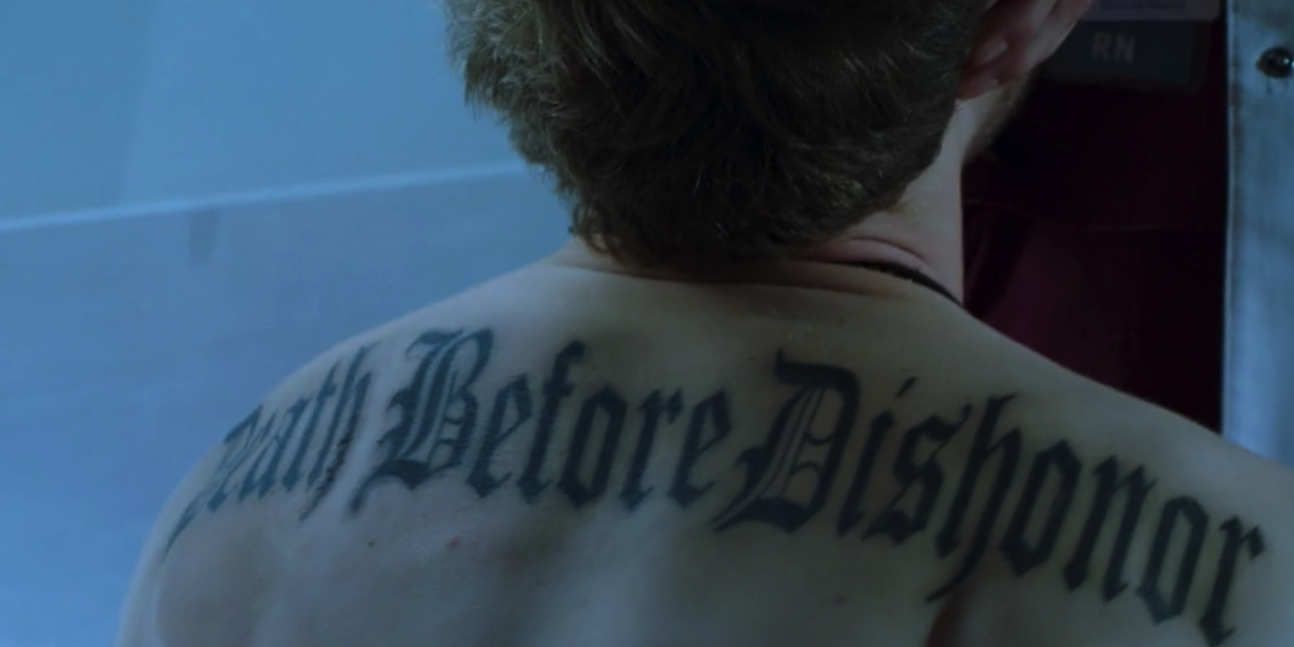 Matt Czuchry as Dr. Conrad Hawkins with a back tattoo reading "Death Before Dishonor" on The Resident