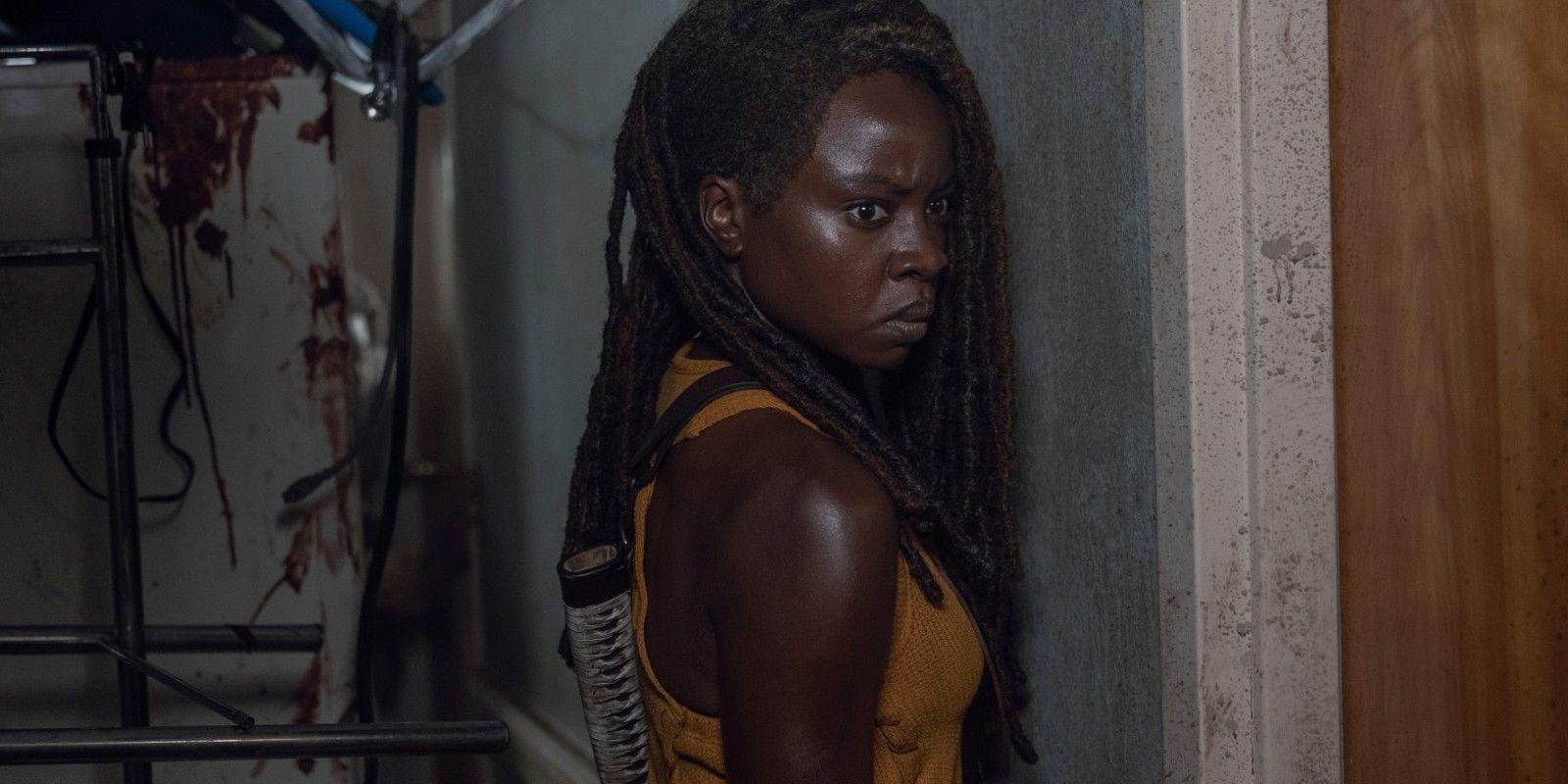 Michonne in The Walking Dead season 10 in a dark room, looking scared and angry.