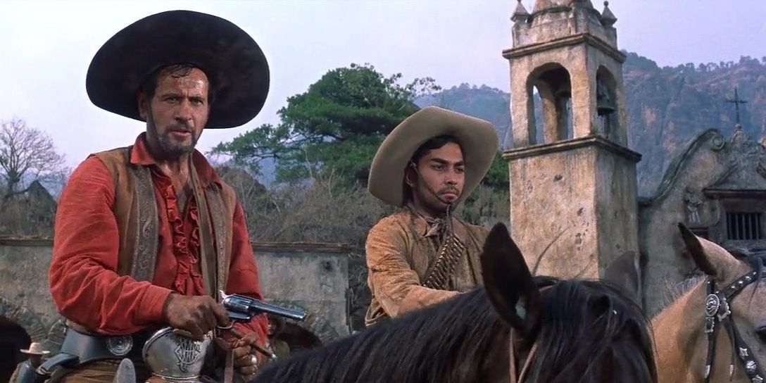 Eli Wallach holding a gun on horseback in The Magnificent Seven