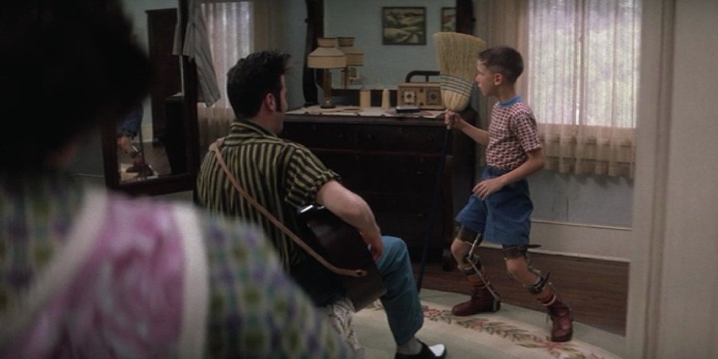 Forrest Gump dancing while Elvis Presley plays the guitar in the Forrest Gump movie
