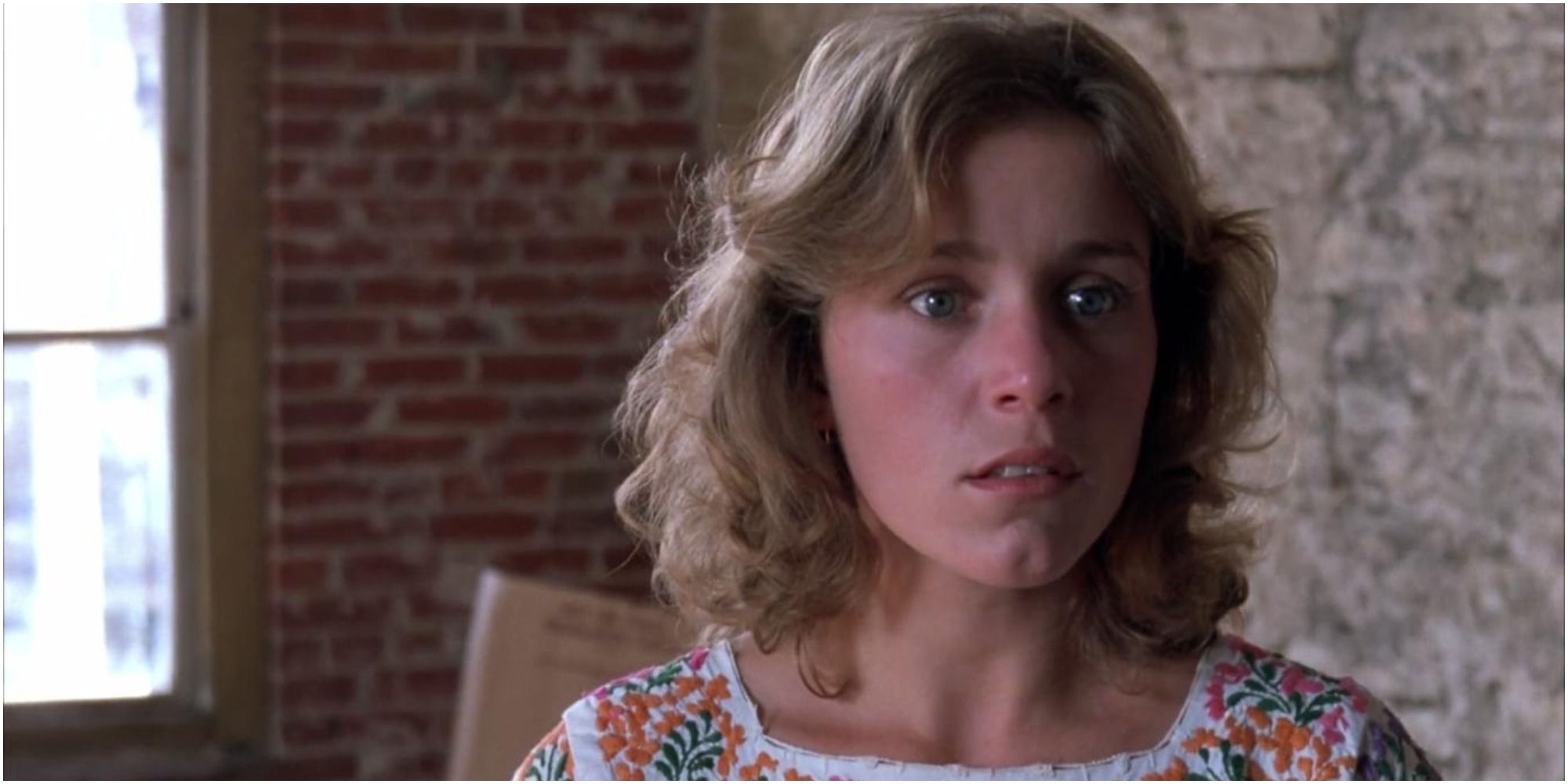 Abbie looks frightened in a warehouse in Blood Simple