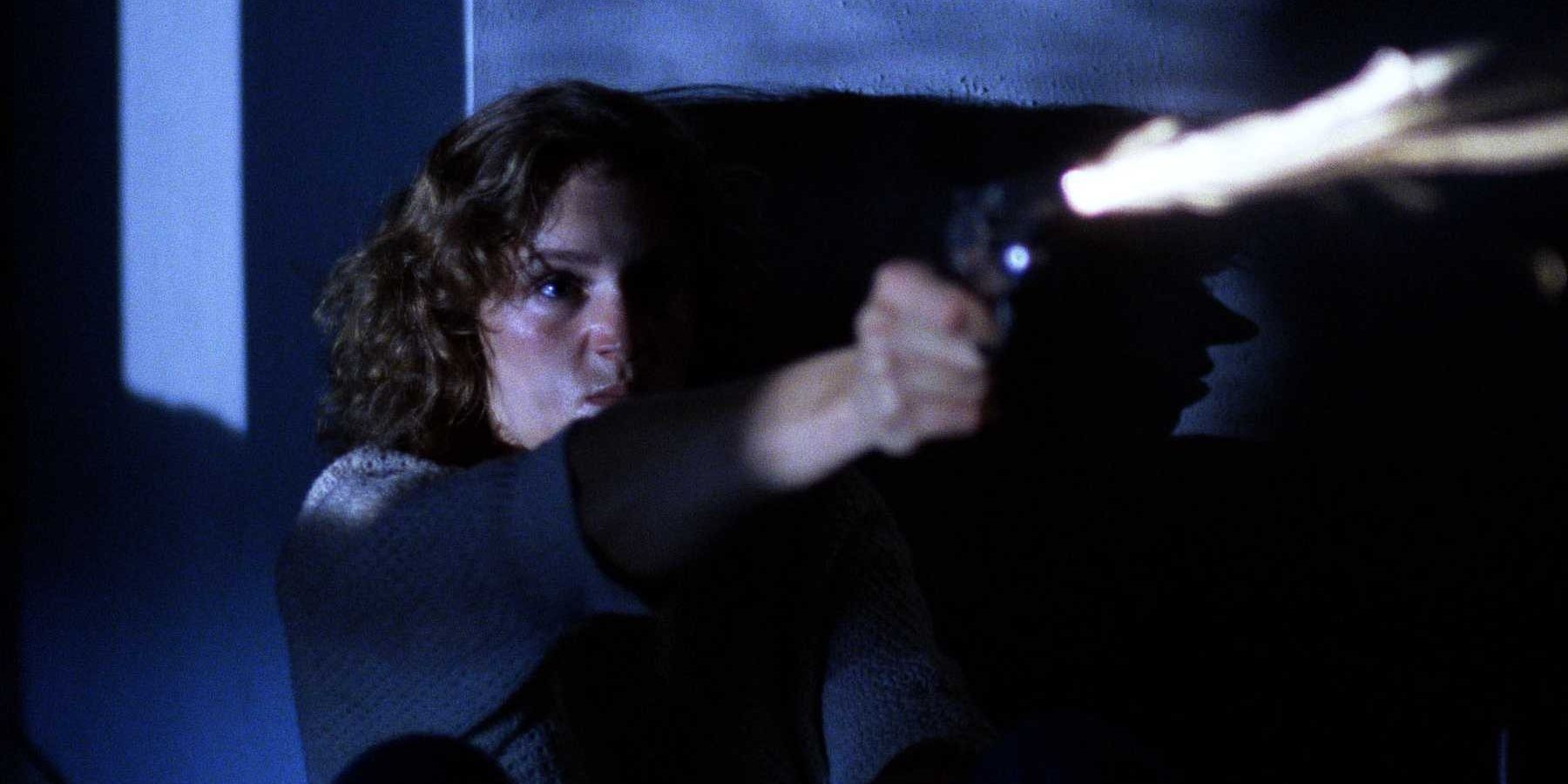 Frances McDormand fires a gun in Blood Simple