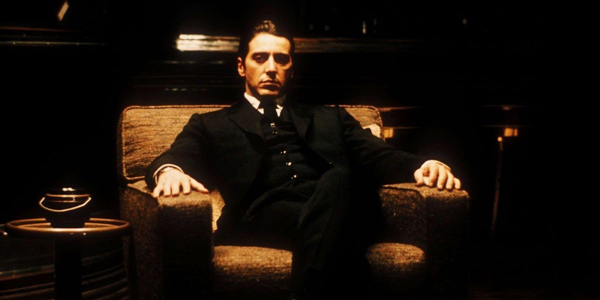 Michael Corleone sitting in a chair looking serious in Godfather II