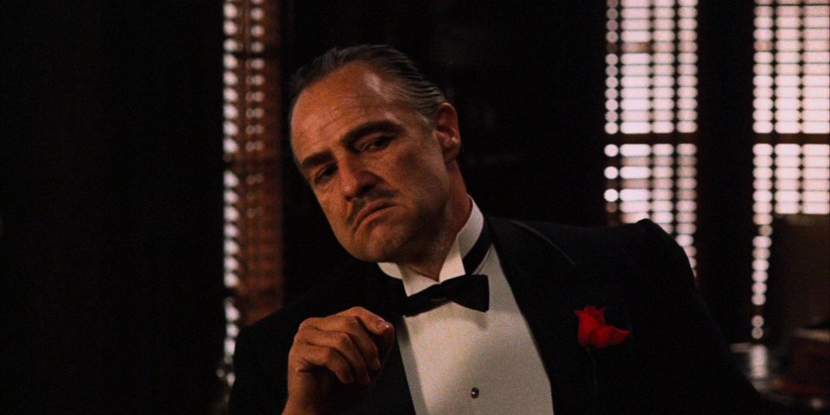 Don Corleone wearing a suit and sitting in The Godfather.