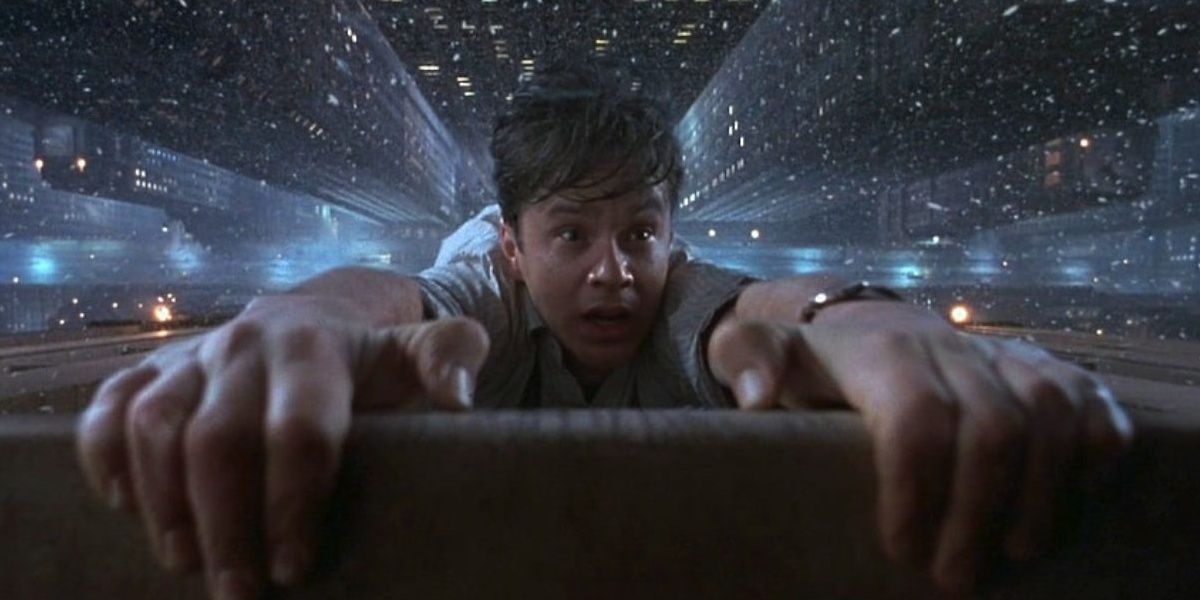 Tim Robbins hangs from a building from The Hudsucker Proxy