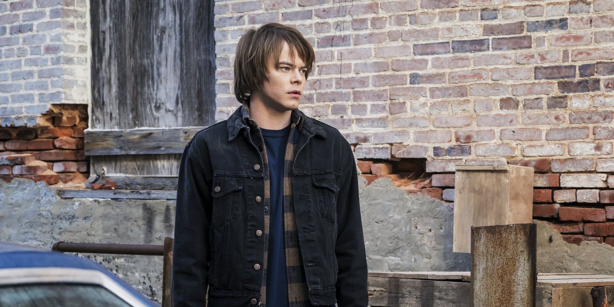 Jonathan Byers standing in alley in Stranger Things