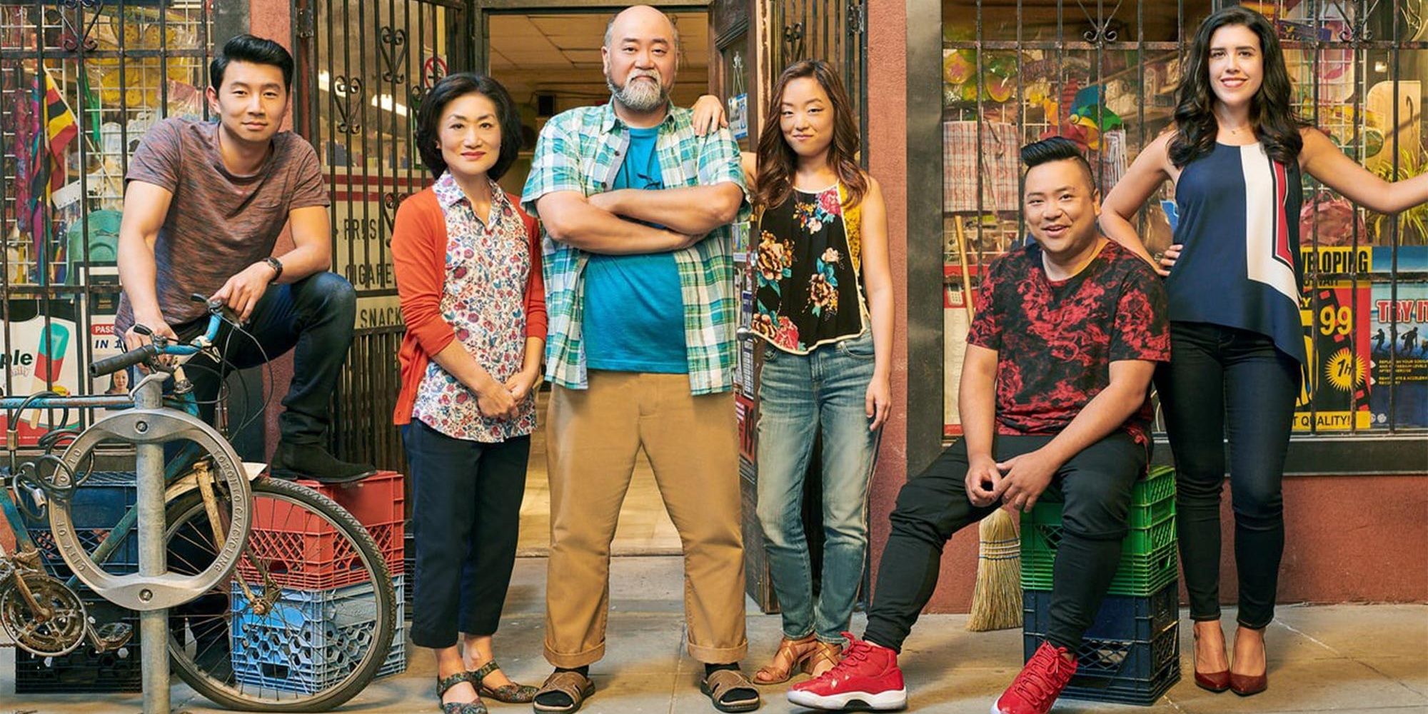 The cast of Kims Convenience stands in front of a store.