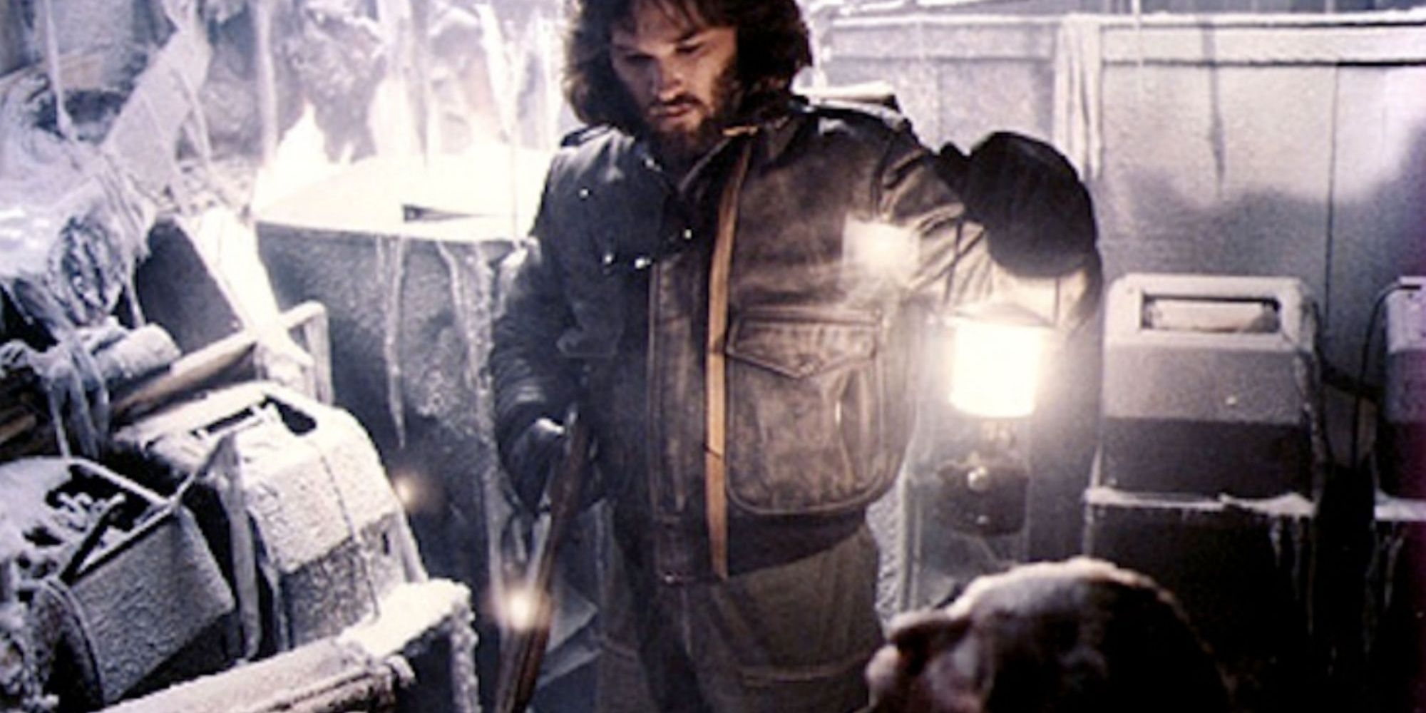 Kurt Russell hold a lantern in The Thing 1982