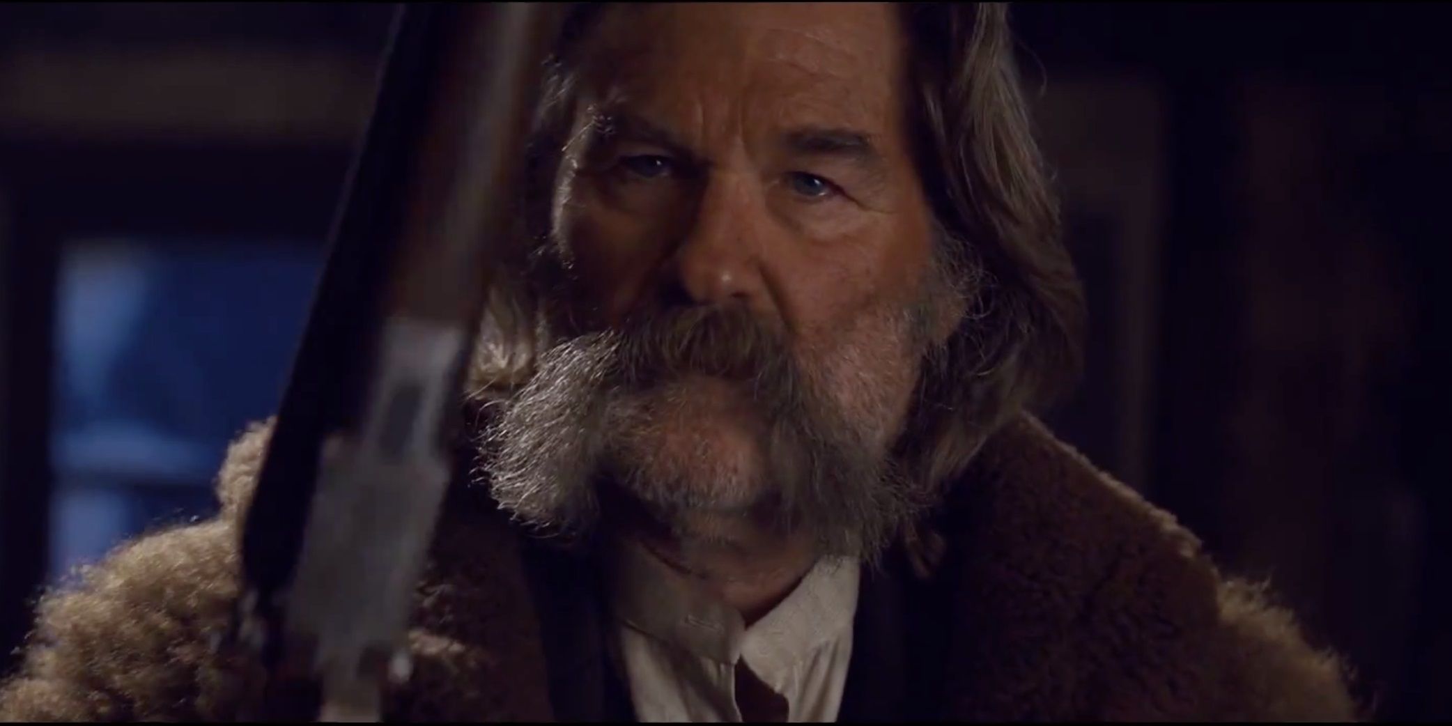 Kurt Russell holding a rifle in The Hateful Eight