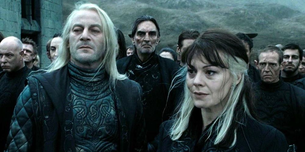 Lucious and Narcissa with a group of Death Eaters