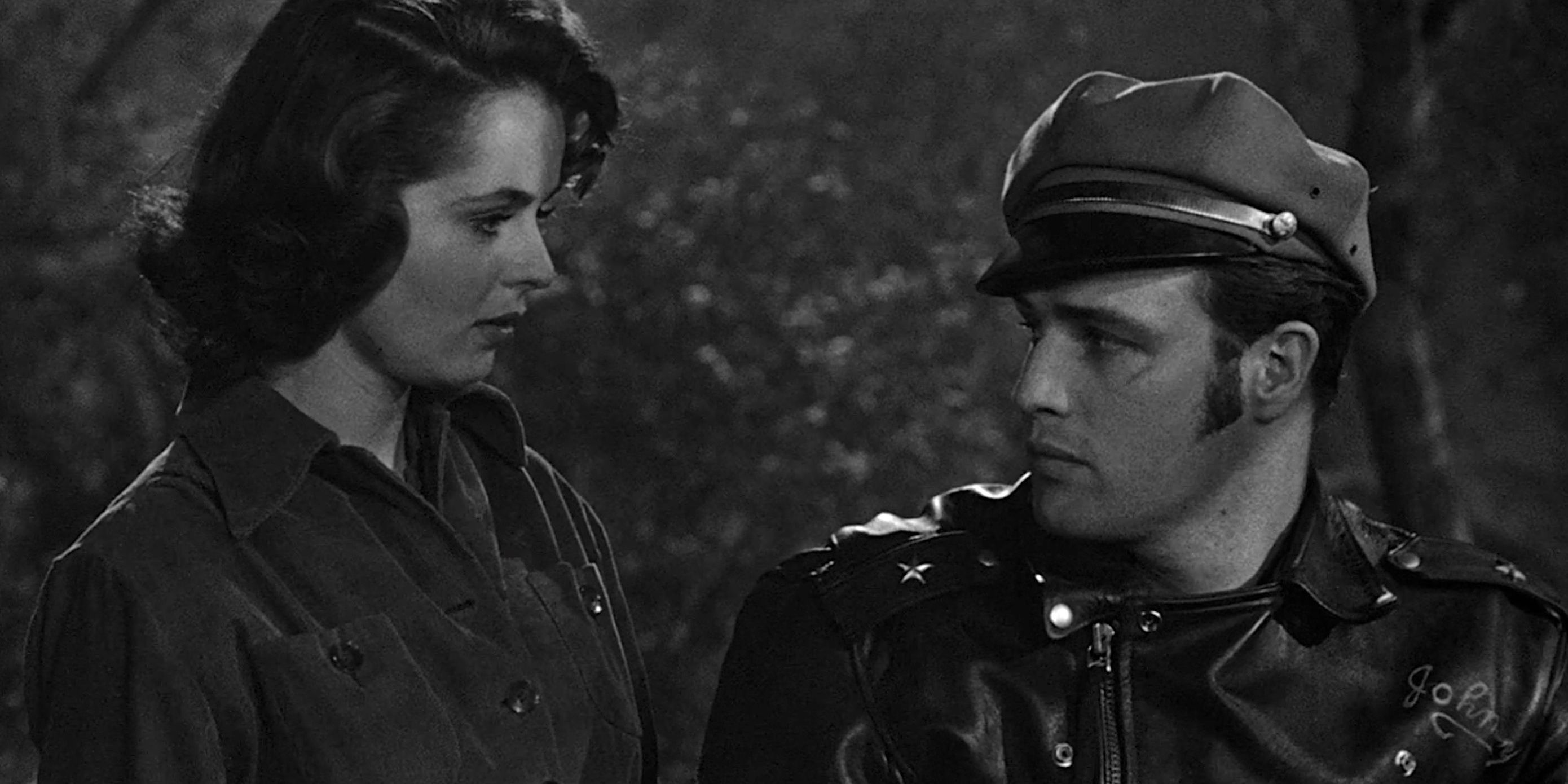 Black and white photo of Mary Murphy and Marlon Brando looking at each other in The Wild One