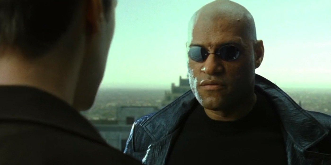Morpheus speaking with Neo on a rooftop in The Matrix