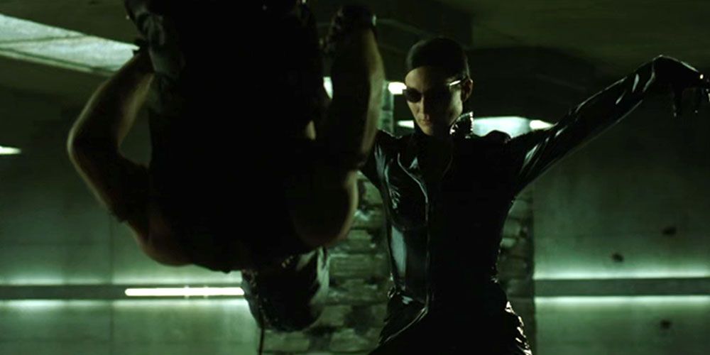 Trinity does a leaping kick to take out an enemy in The Matrix Revolutions