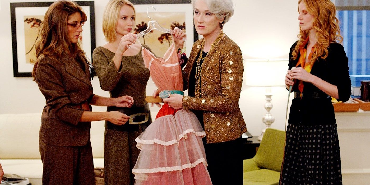 Miranda Priestly holding a dress and looking unhappy in The Devil Wears Prada