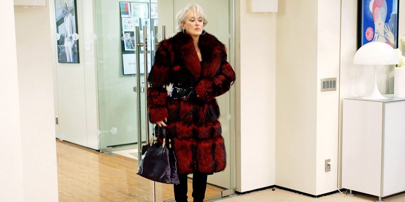 Miranda walks into her office and begins to unbutton her coat in The Devil Wears Prada