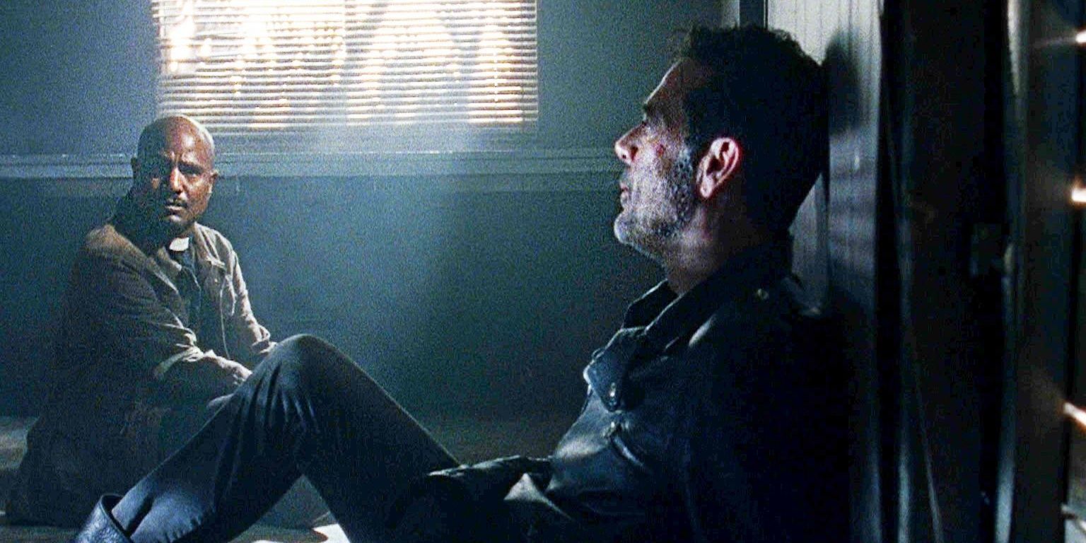 Negan hiding from zombies with Father Gabriel in The Walking Dead.