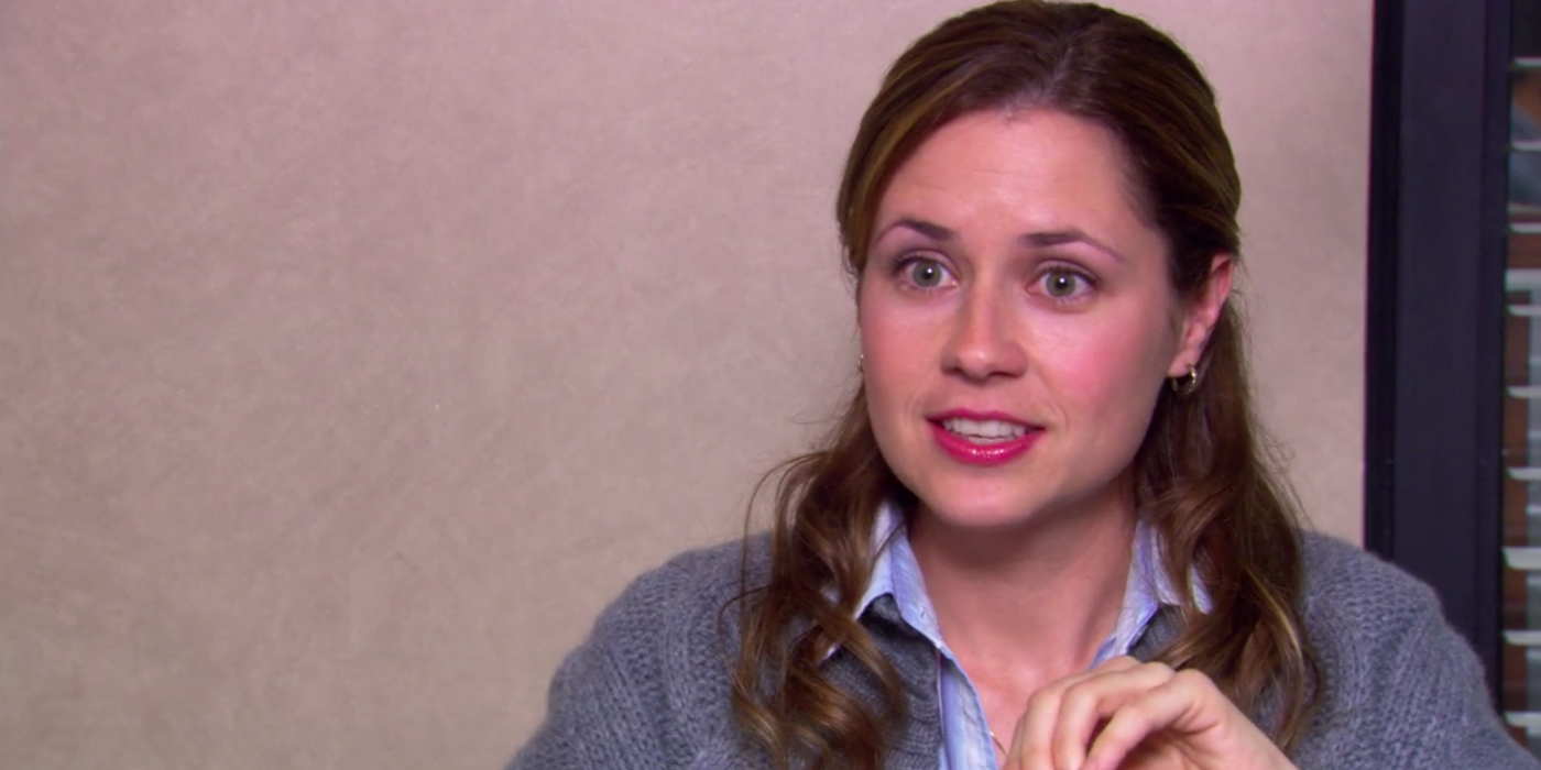 Pam Beesley smiling at the camera in a confessional for The Office