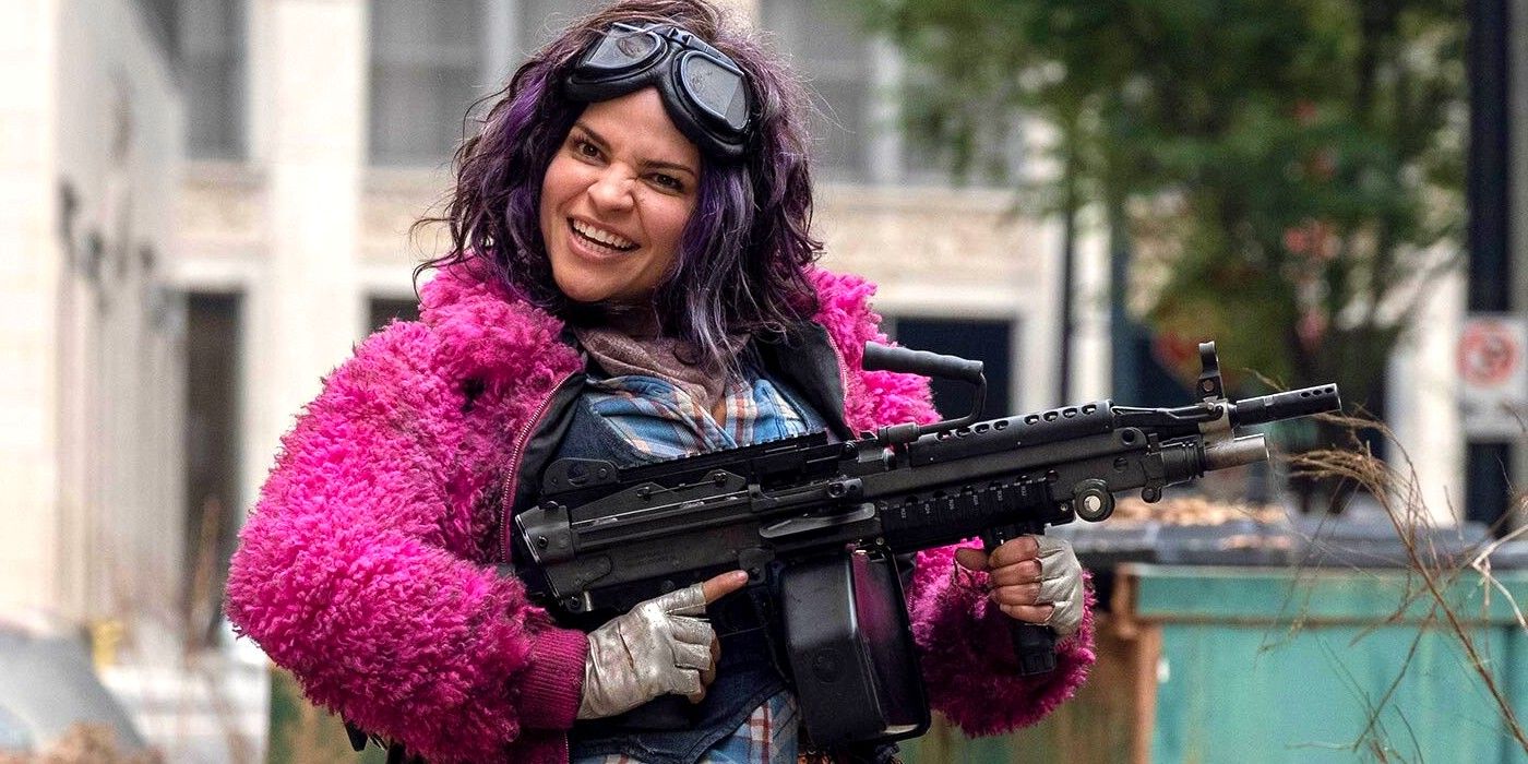 Paola Lazaro in fluffy pink coat and holding gun as Princess on AMC The Walking Dead