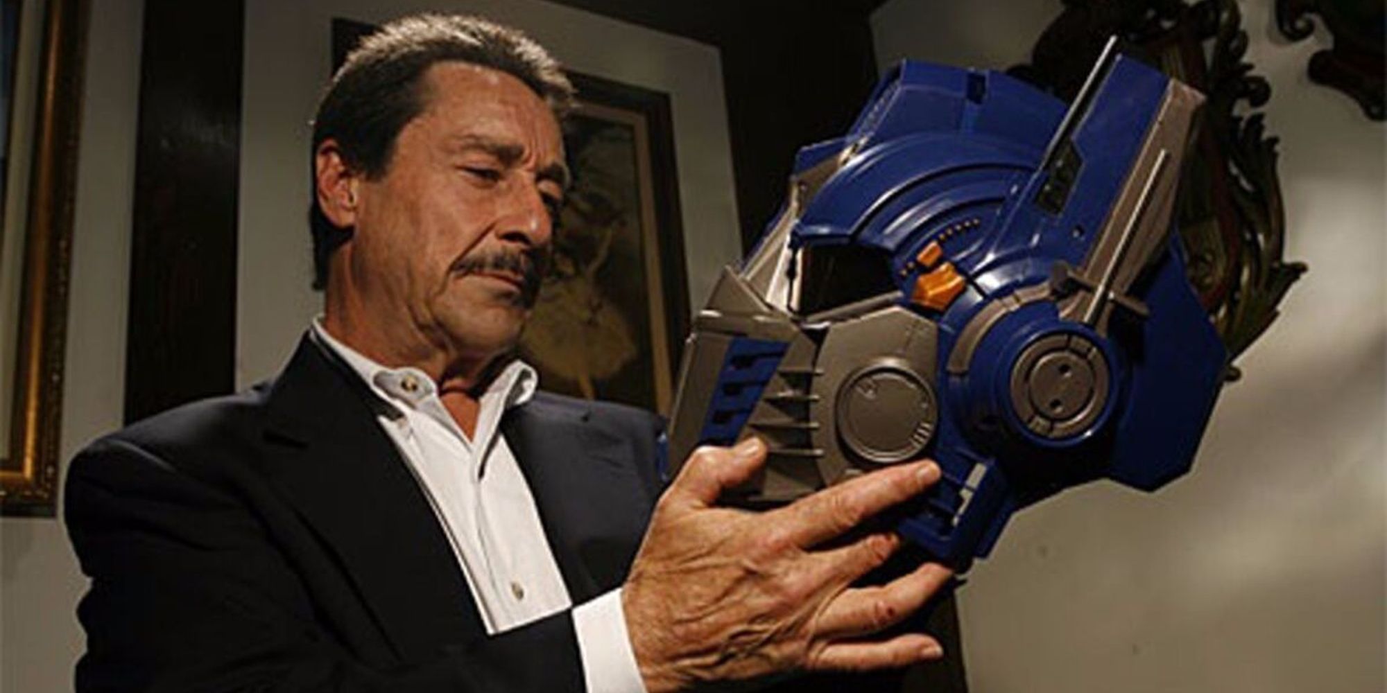 Peter Cullen holding the mask of Optimus Prime