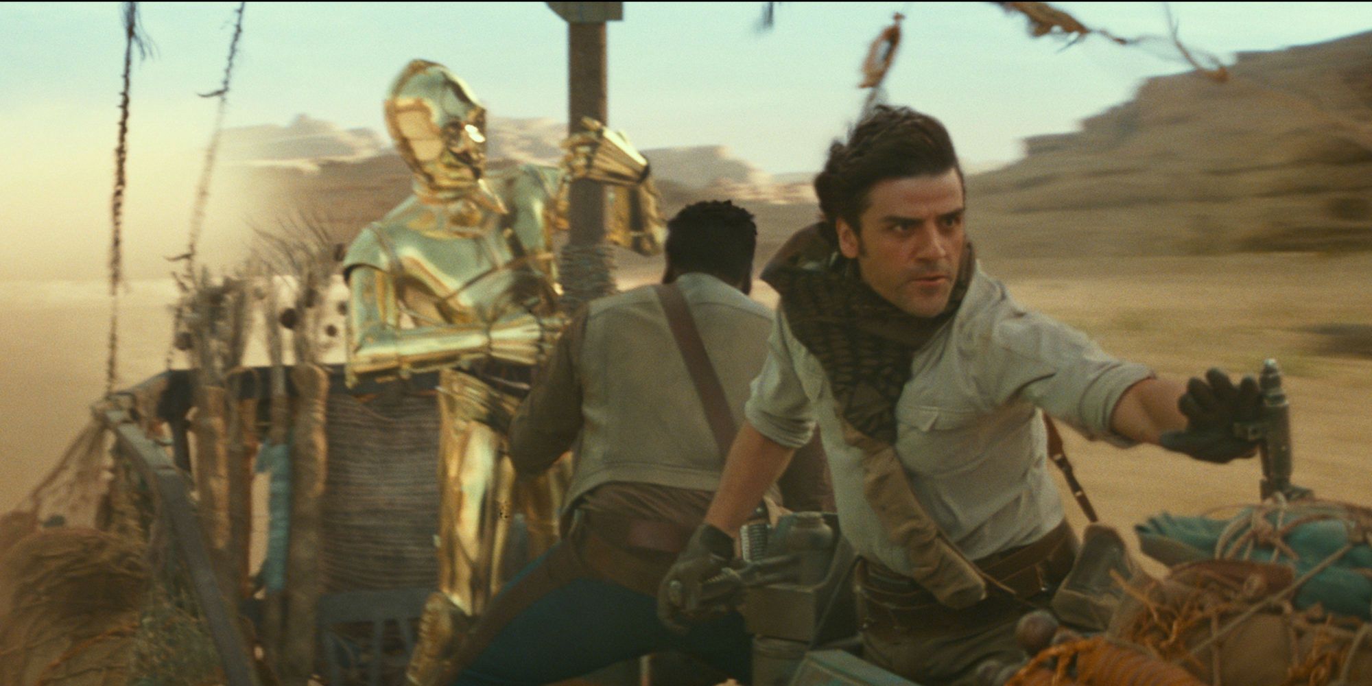 Poe, Finn, and C-3PO navigate through Pasaana, trying to escape the First Order forces in The Rise of Skywalker