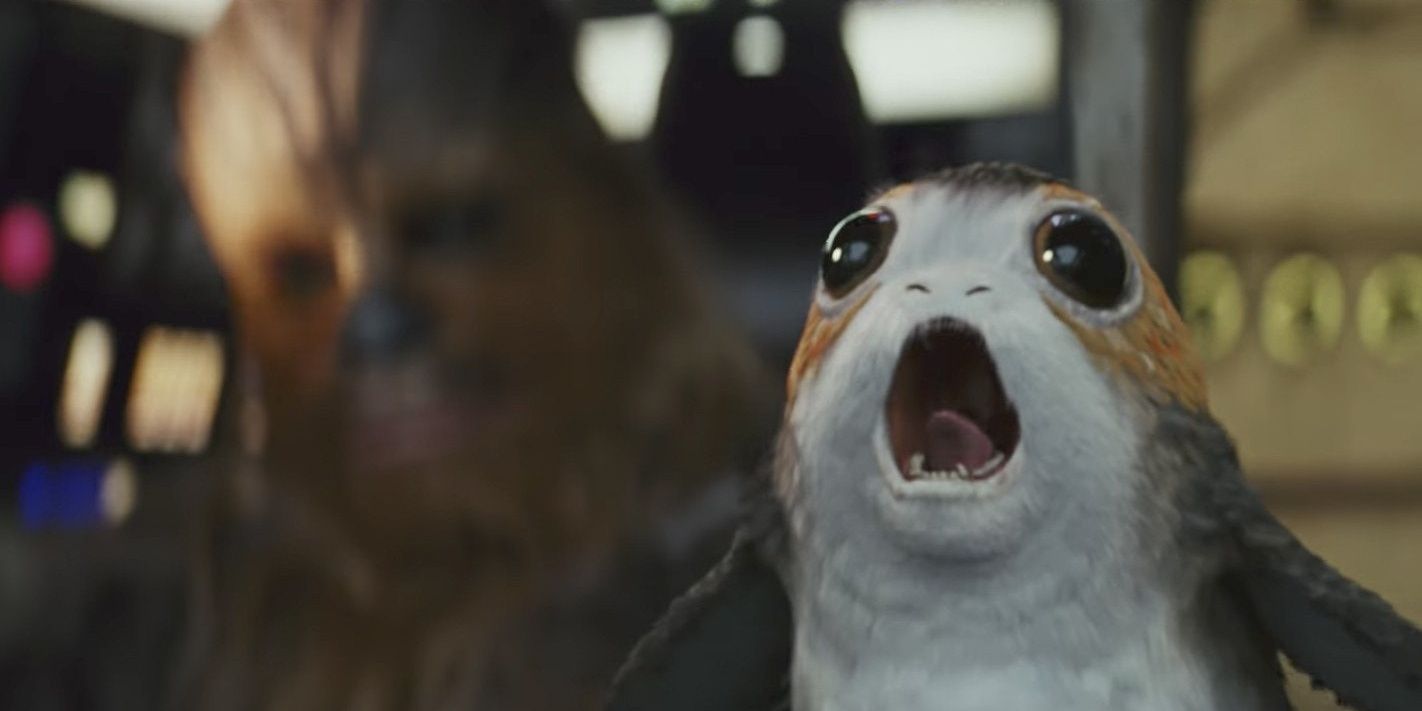 A Porg screams in thre Millennium Falcon before Chewie pushes it aside in The Last Jedi
