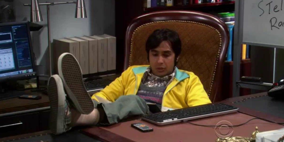 Raj sitting at his desk sulking on TBBT