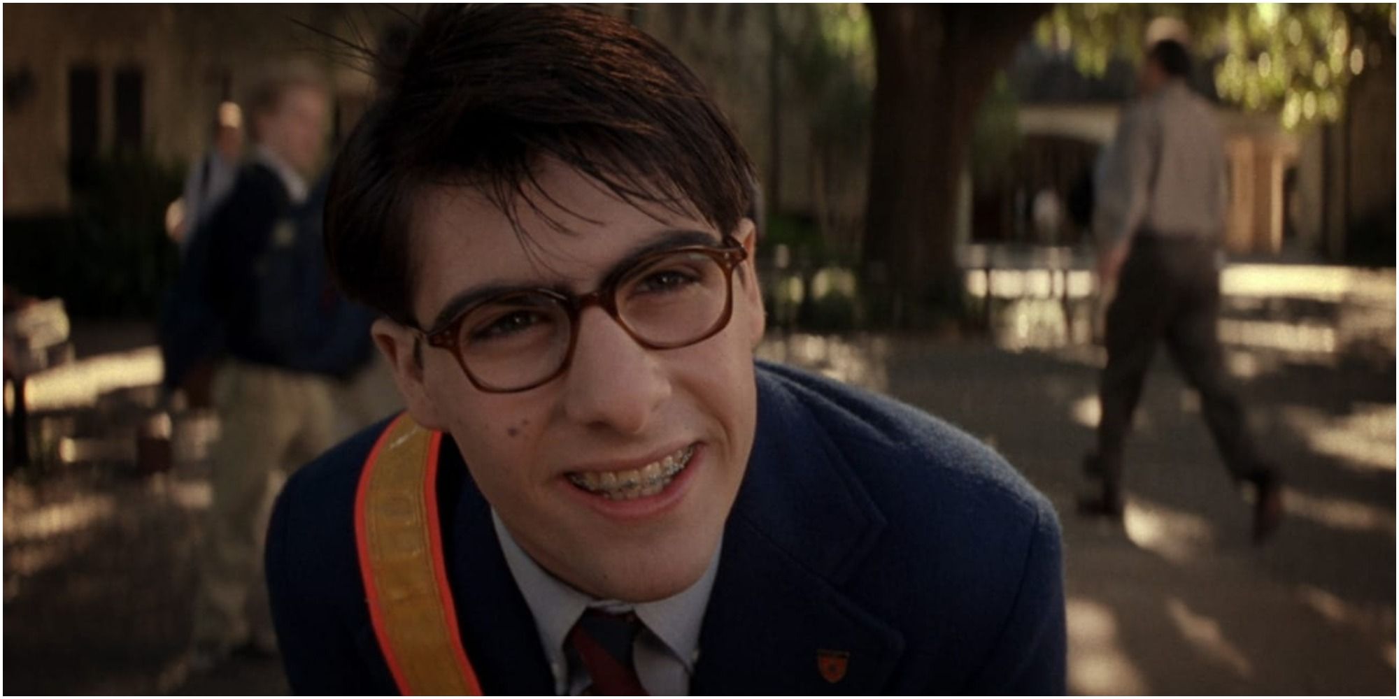 Jason Schwartzman as Max Fischer outside school in Rushmore