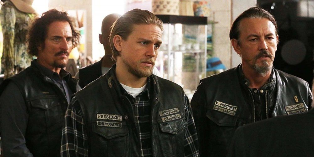 Several cast members from Sons of Anarchy stand and talk to someone
